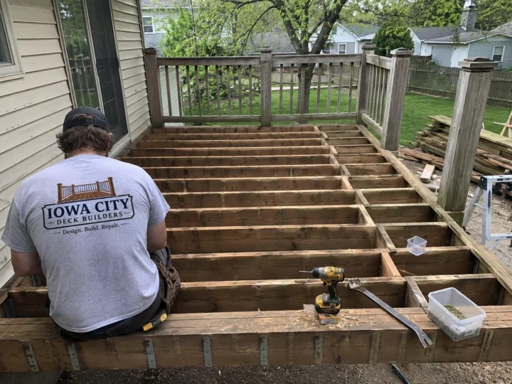 Exposed deck joists during structural deck repair and rebuilding in the Iowa City service area.