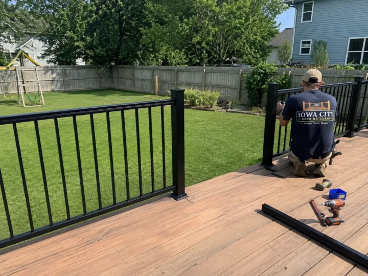 Finished composite deck with black aluminum railing in Shueyville, Iowa.