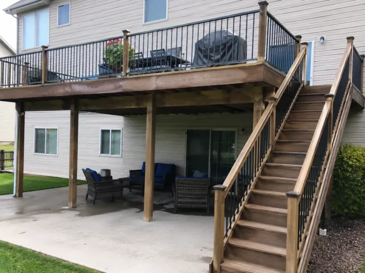 Finished elevated wood deck with dual stairs in Coralville, Iowa.