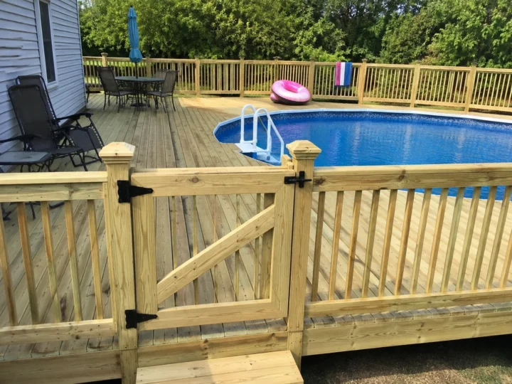 Finished pool deck with wood gate in West Liberty, Iowa.