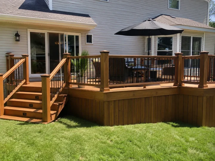 Finished stained wood deck with black railing in Lone Tree, Iowa.