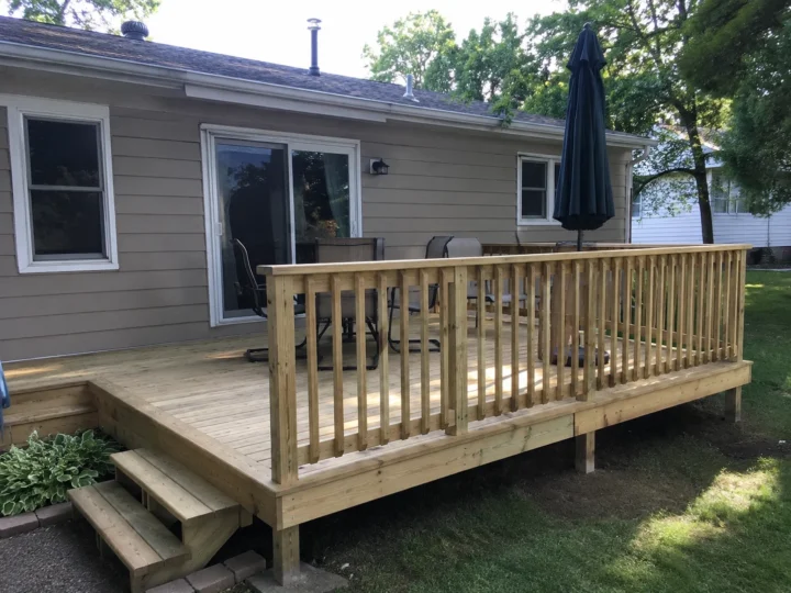 Finished wood deck with railing and steps in Riverside, Iowa.