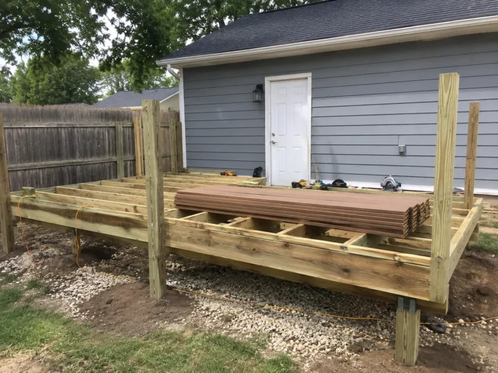 Ground level deck framing with new boards in Oxford, Iowa.