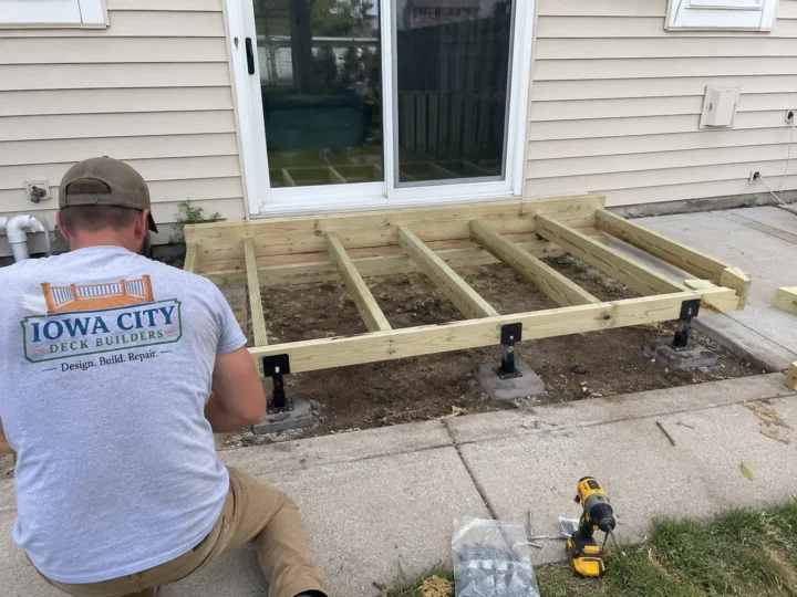 Ground level wood deck framing in Marengo, Iowa.
