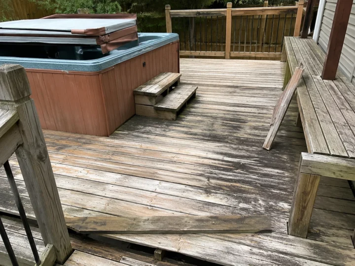 Weathered hot tub deck before repair in West Liberty, Iowa.
