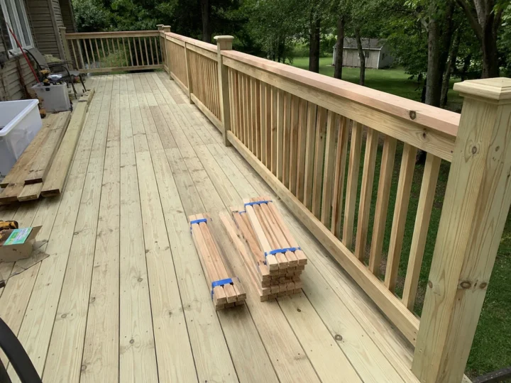 Weathered wood deck boards and railing showing common deck repair warning signs in Iowa City, Iowa.