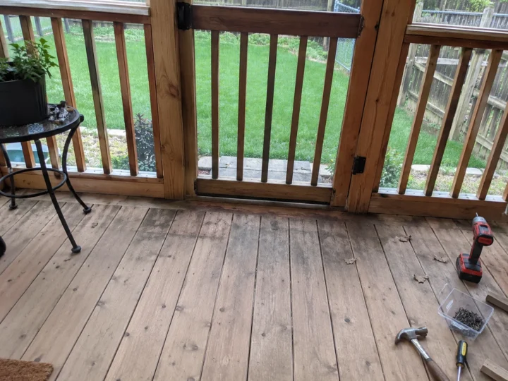Weathered wood deck surface and railing in Nichols, Iowa.